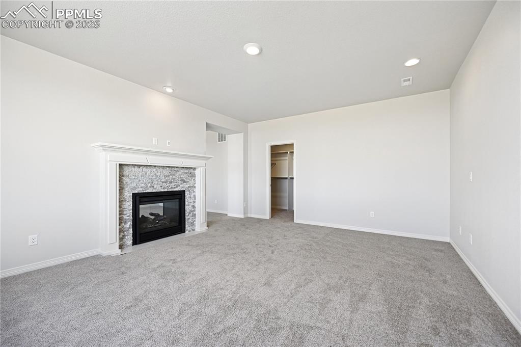 Image 14 of 36: Unfurnished living room featuring light colored carpet, recessed lighting, 