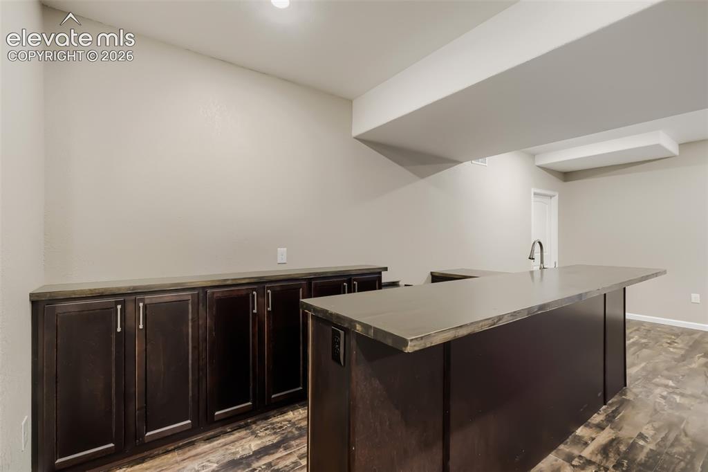 Image 34 of 50: wet bar with wine fridge