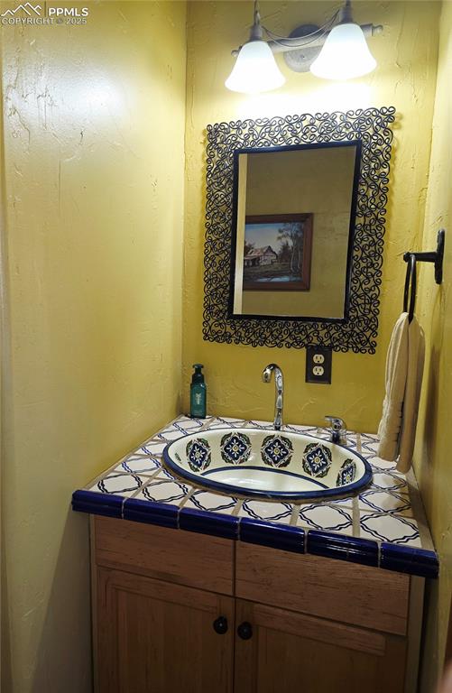 Image 13 of 42: Bathroom with vanity and a textured wall