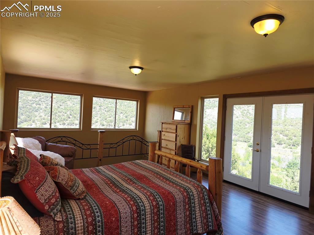 Image 15 of 42: Bedroom featuring wood finished floors, french doors, and access to exterio