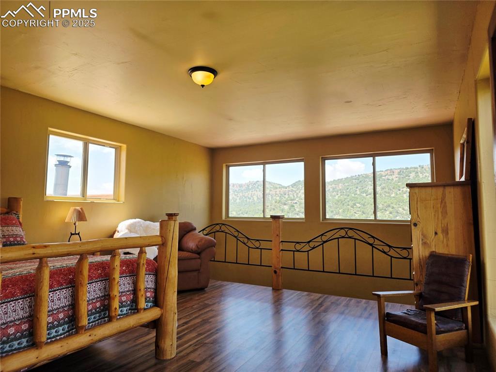 Image 17 of 42: Bedroom with wood finished floors