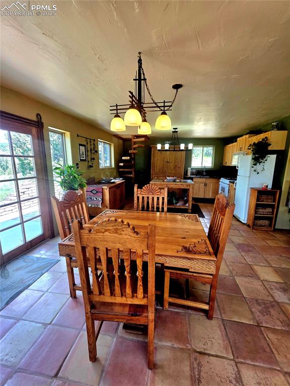 Image 6 of 42: Dining space featuring a chandelier