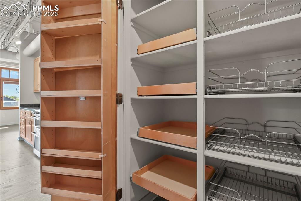 Image 14 of 50: Great pantry with roll out shelves and wire baskets