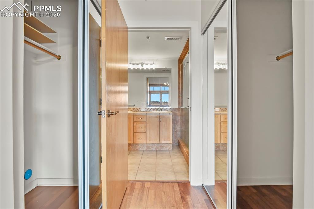 Image 20 of 50: Primary bedroom walk-in closet