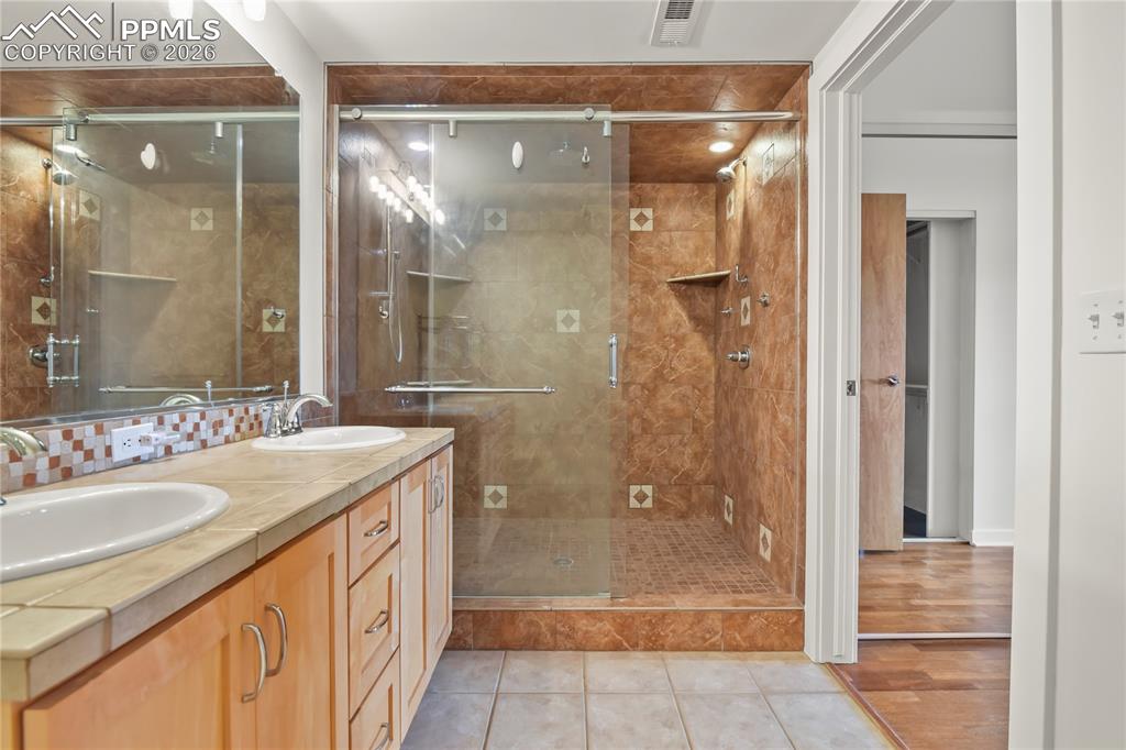 Image 22 of 50: Renovated primary bath with dual head plus rain head oversized shower