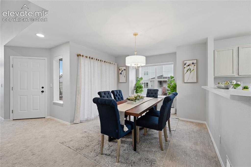 Image 10 of 26: Dining room walks out to the patio, perfect for having a glass of wine afte