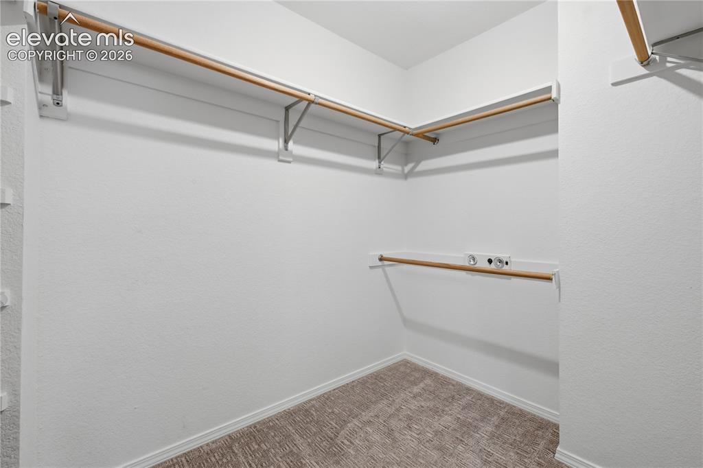 Image 21 of 26: Primary bedroom walk in closet