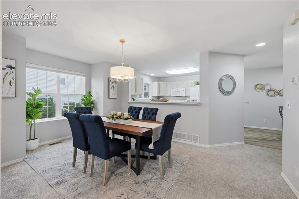 Image 3 of 26: Connected dining room open to the kitchen for entertaining and conversation