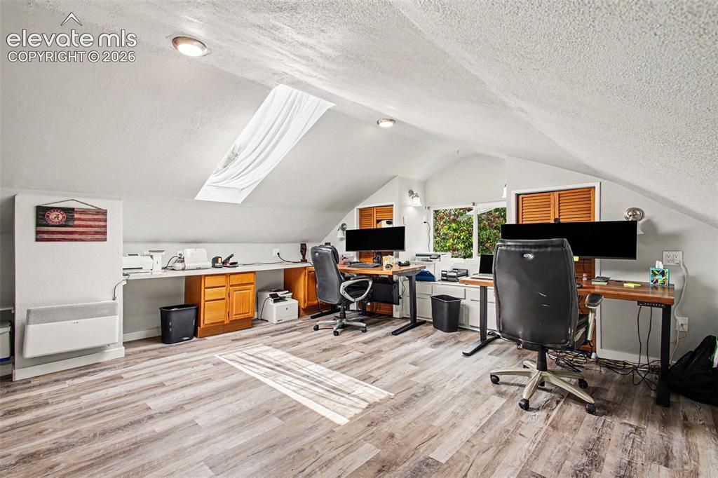 Image 16 of 36: Newer LVP floors and skylight