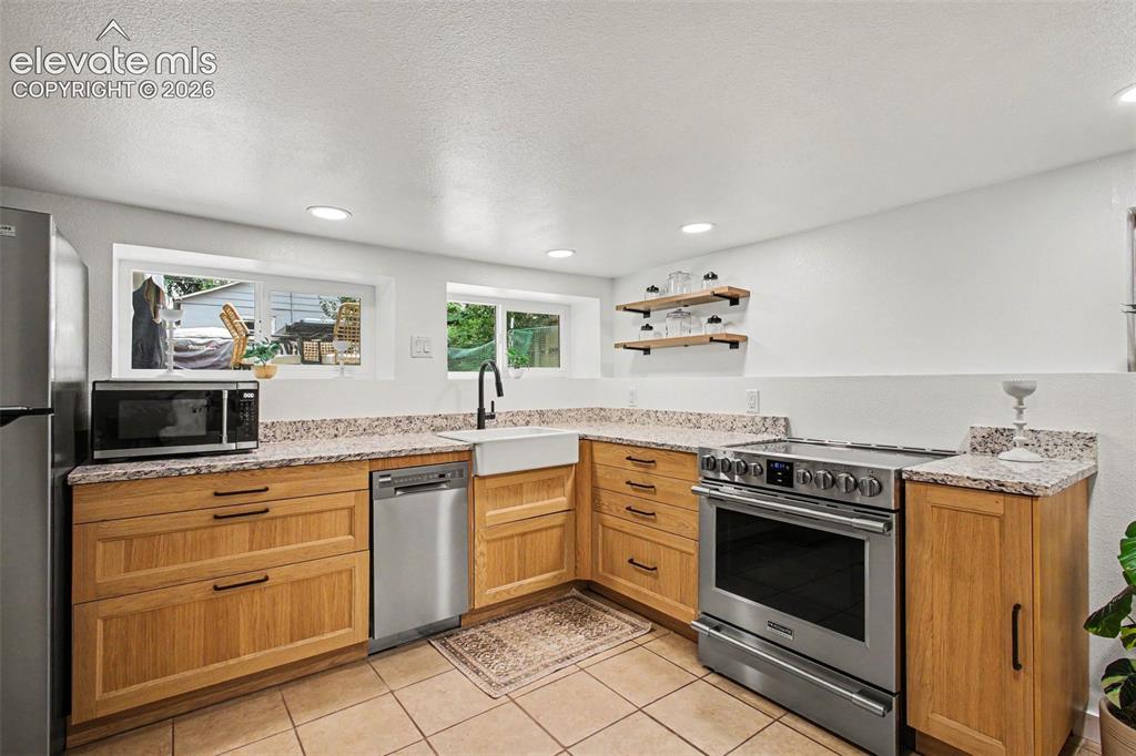 Image 20 of 36: Separate, remodeled kitchen in basement!