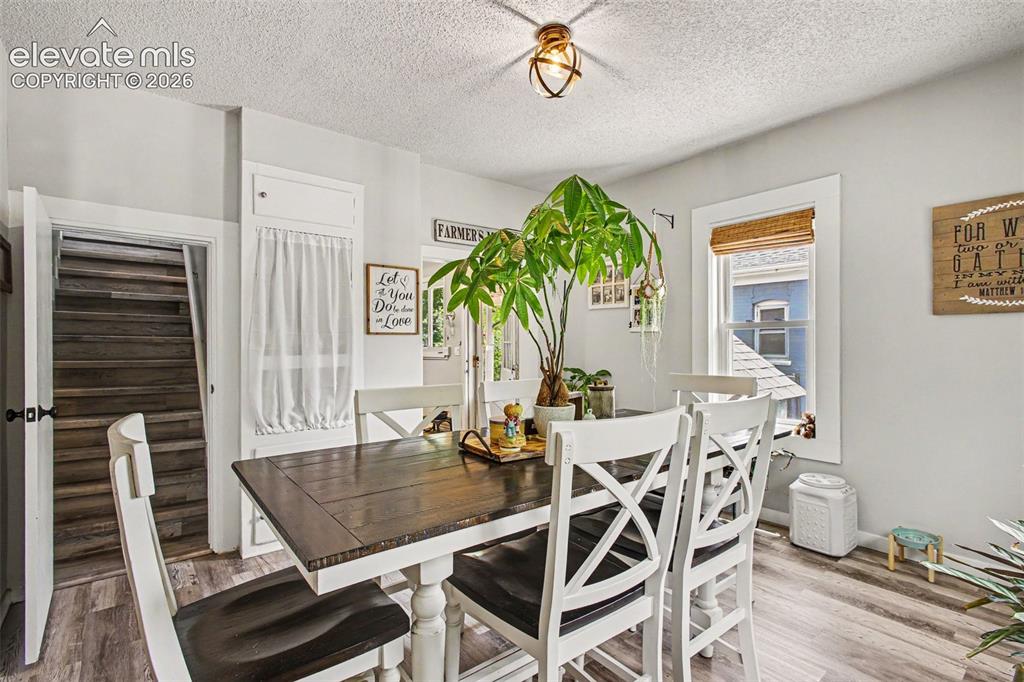 Image 6 of 36: Dining room connects to kitchen, living room, and upstairs bedroom/office a