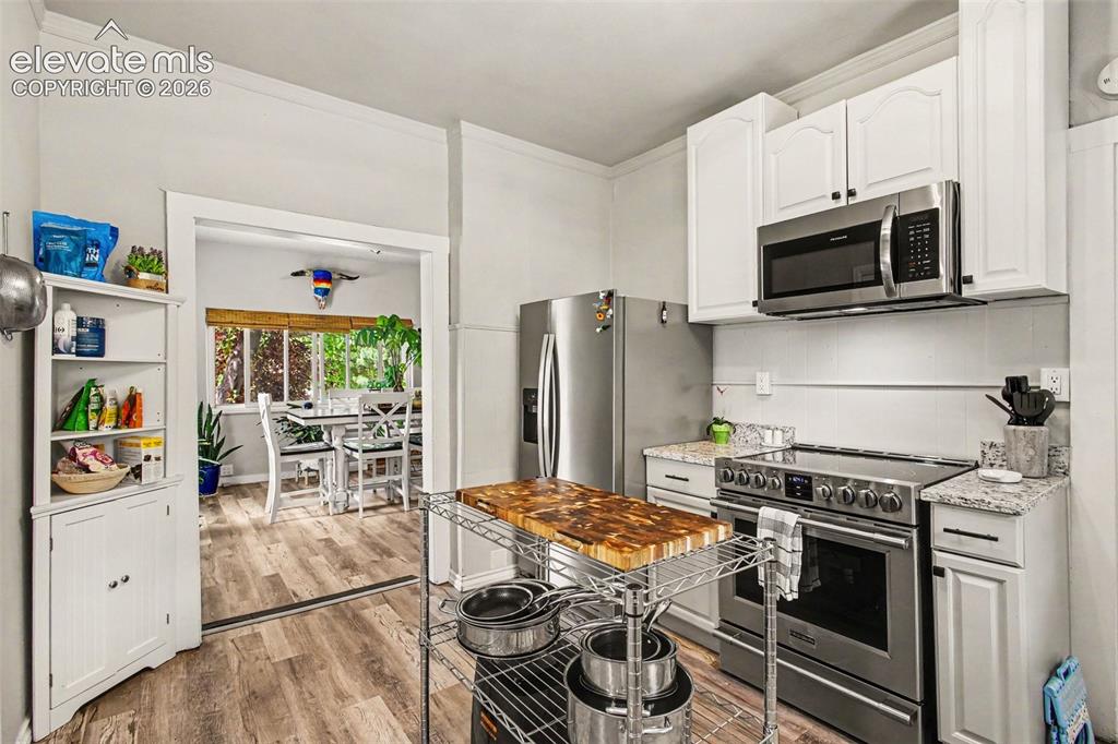 Image 9 of 36: Updated cabinets. Portable island is included!