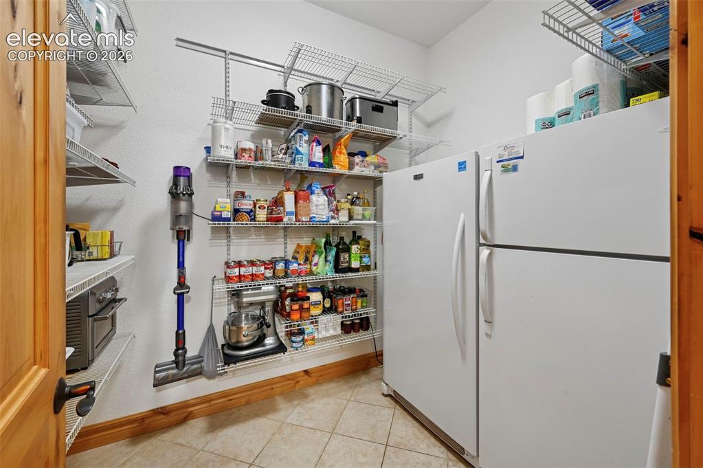 Image 14 of 48: Pantry with full size refrigerator and freezer that conveys with property!