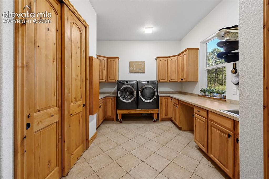 Image 15 of 48: Laundry / Hobby / Organization room with utility sink, closet and built in