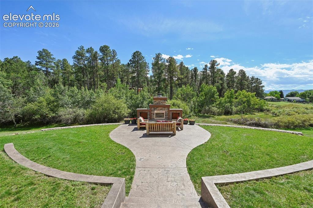 Image 36 of 48: Outdoor fireplace and lawn - perfect for entertaining!