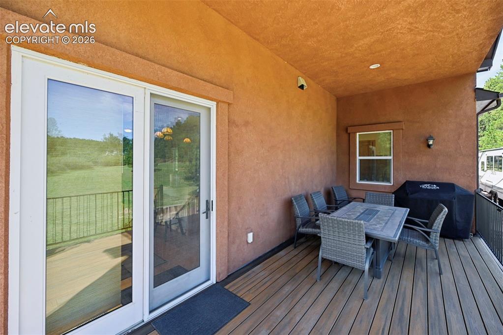 Image 40 of 48: Covered porch off kitchen dining area - perfect for grilling and dining!
