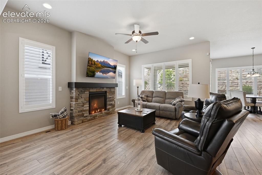 Image 8 of 33: Cozy stone fire place and plantation shutters!