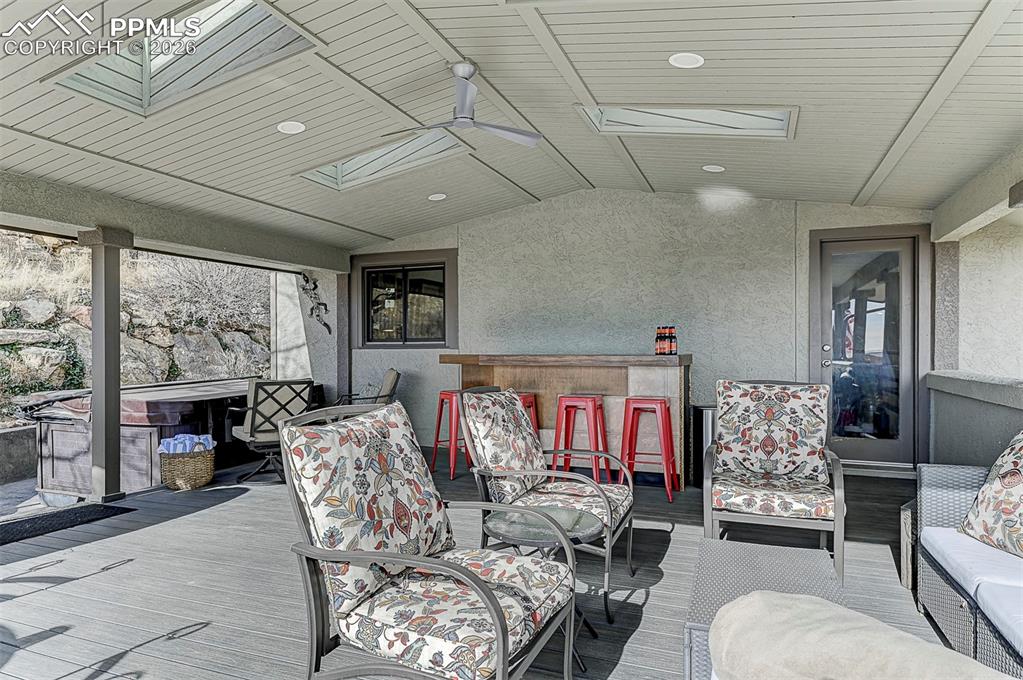 Image 22 of 41: Updated deck with fan, skylights, trex deck, spa,  stamped concrete, & more