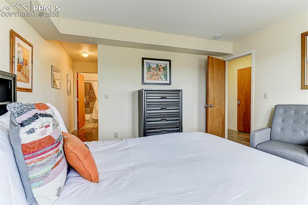 Image 28 of 41: Bedroom featuring ensuite bath, walk-in closet, casement windows, baseboard