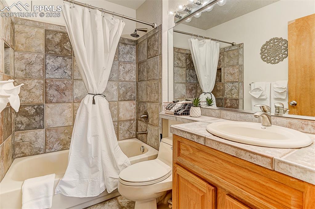 Image 29 of 41: Bathroom featuring shower / tub combo, tile floors, ensuite bathroom