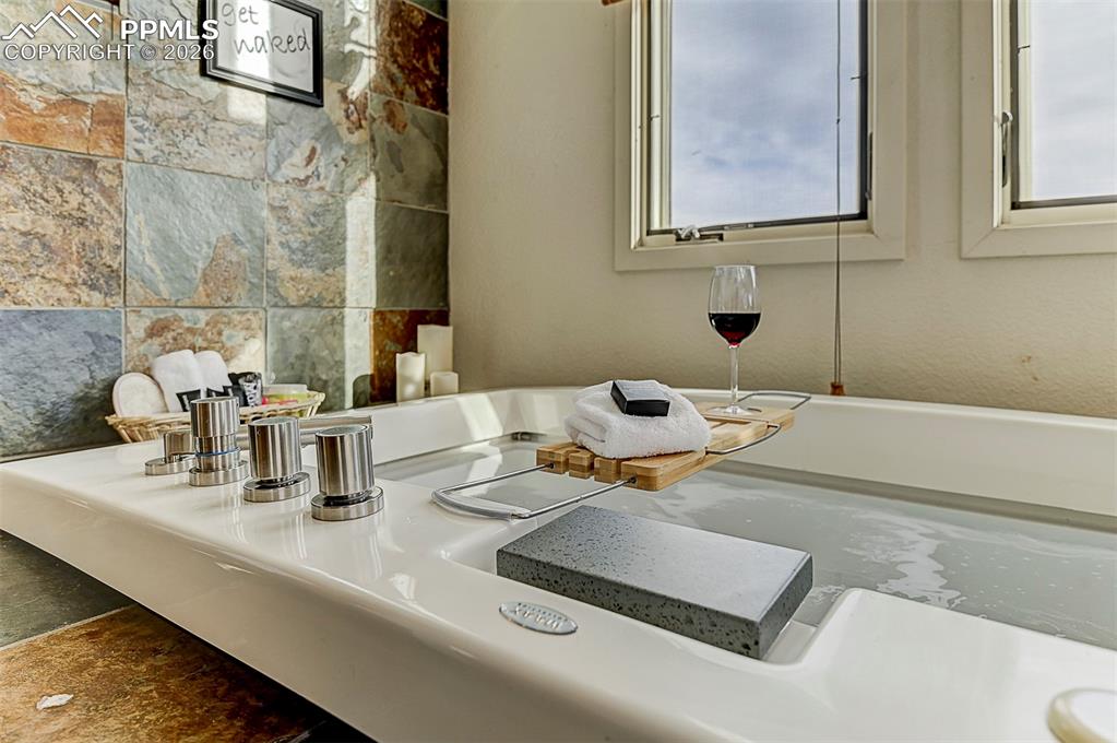 Image 38 of 41: Jetted tub with natural light