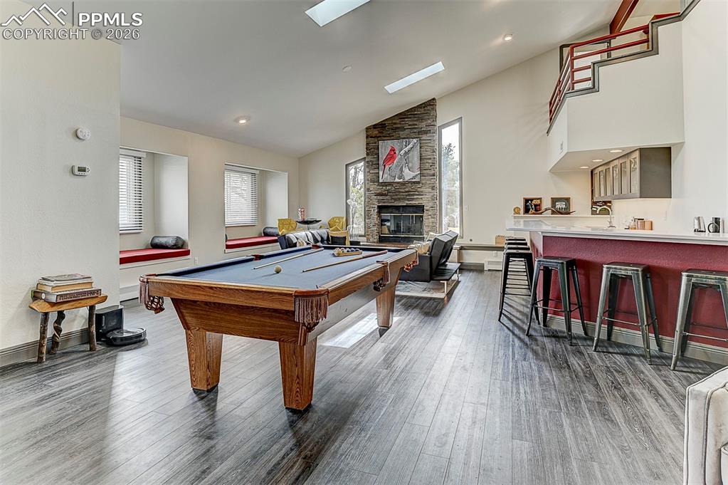 Image 9 of 41: Rec room featuring healthy amount of natural light, lofted ceiling, billiar