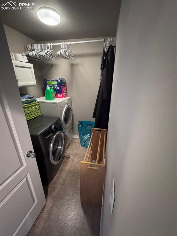 Image 25 of 31: Upper Level Laundry Room with Cabinets & Hanging Rod
