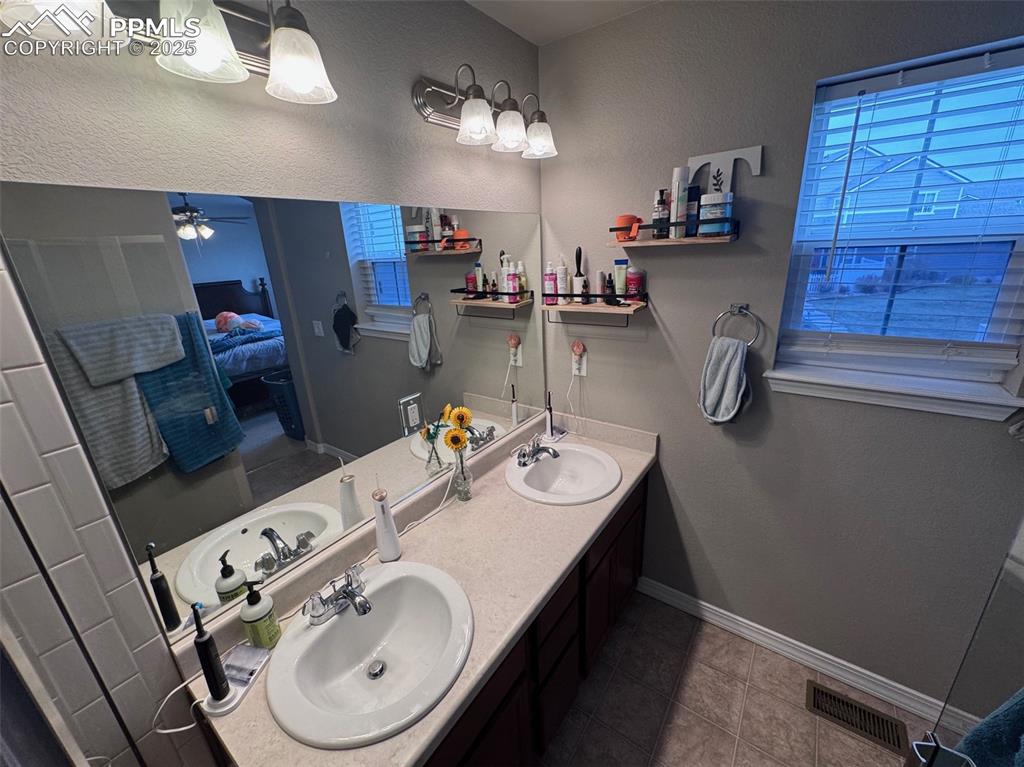 Image 28 of 31: Primary Ensuite Bathroom with Double Vanity, Private Toilet, & Large Shower