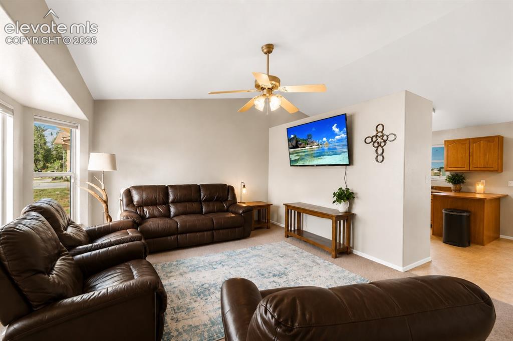 Image 3 of 20: Living area featuring a bay window, ceiling fan, and carpet flooring