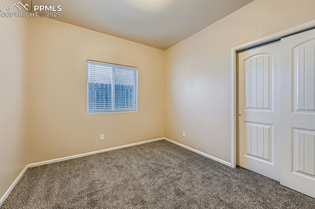 Image 11 of 26: Unfurnished bedroom featuring carpet flooring and a closet