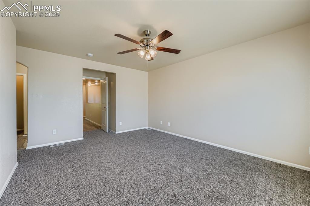Image 15 of 26: Unfurnished bedroom with carpet floors and ceiling fan