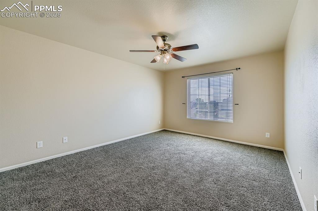 Image 16 of 26: Empty room featuring carpet flooring and ceiling fan