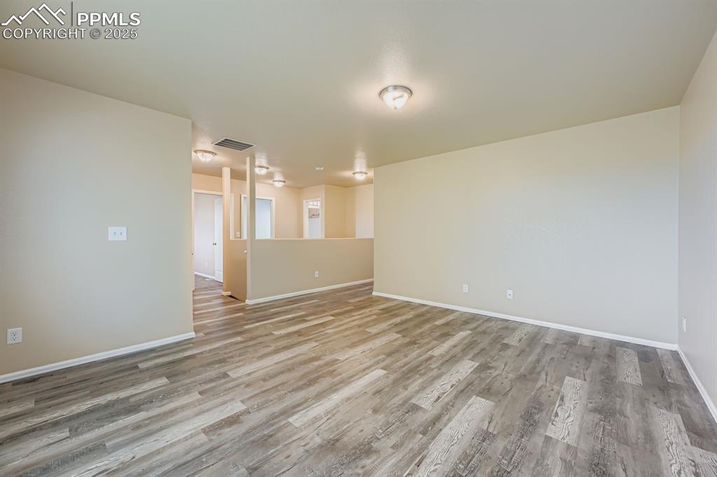 Image 23 of 26: Empty room featuring light wood-style flooring and baseboards