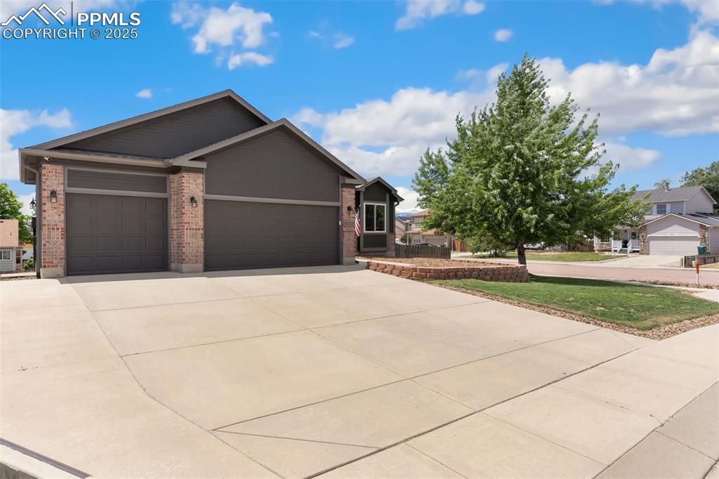 Image 2 of 33: 3 car garage, extended wide driveway