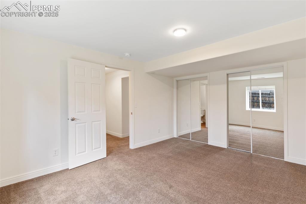 Image 22 of 33: 3rd bedroom, located in basement. Oversized with 2 closets