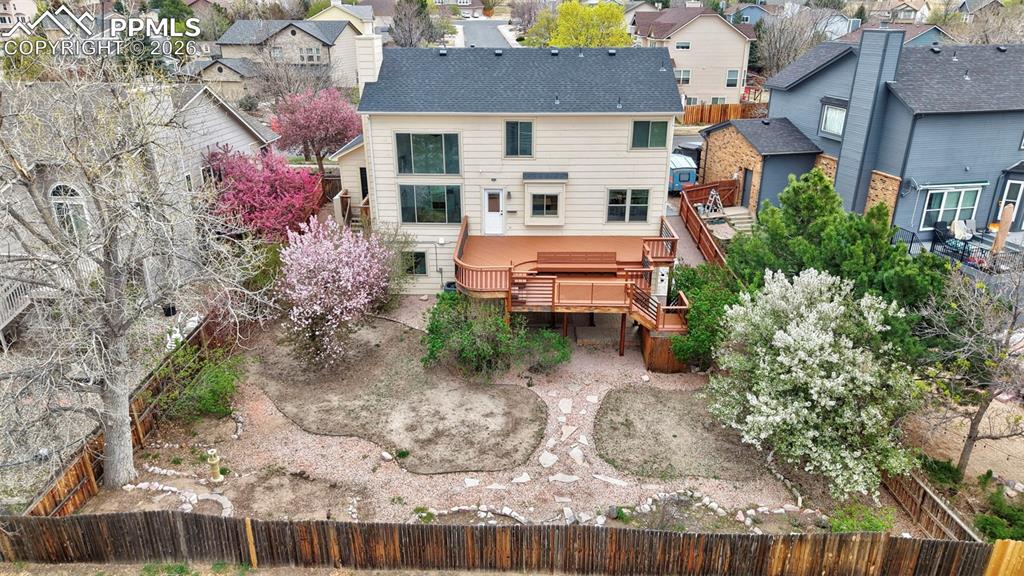Image 10 of 50: Rear view of property featuring a residential view and a deck