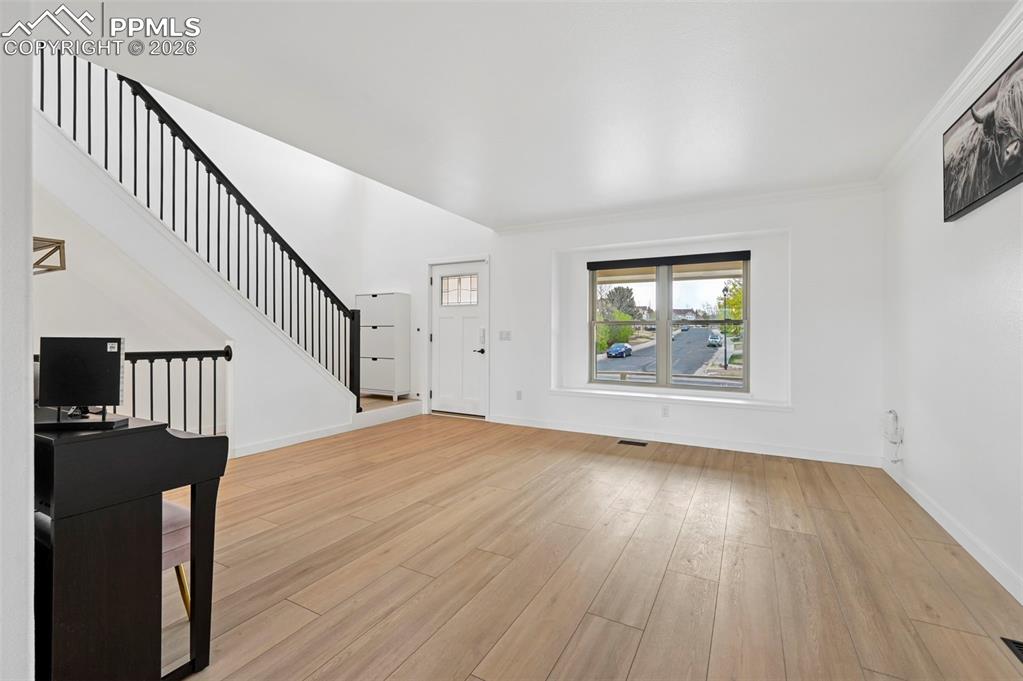Image 12 of 50: Entryway with light wood finished floors and baseboards