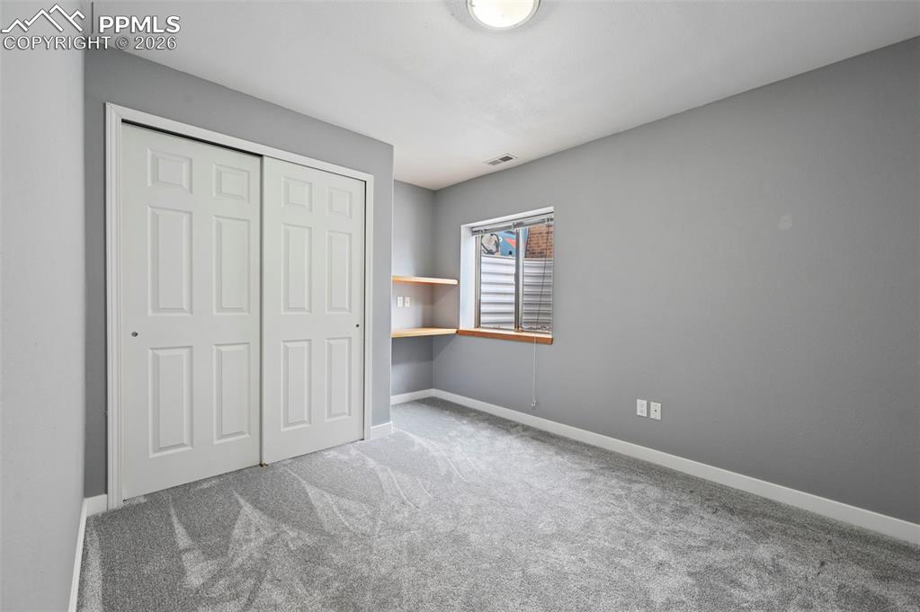 Image 46 of 50: Unfurnished bedroom featuring light carpet and a closet