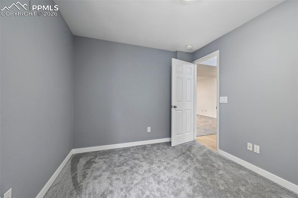 Image 49 of 50: Empty room featuring light carpet and baseboards