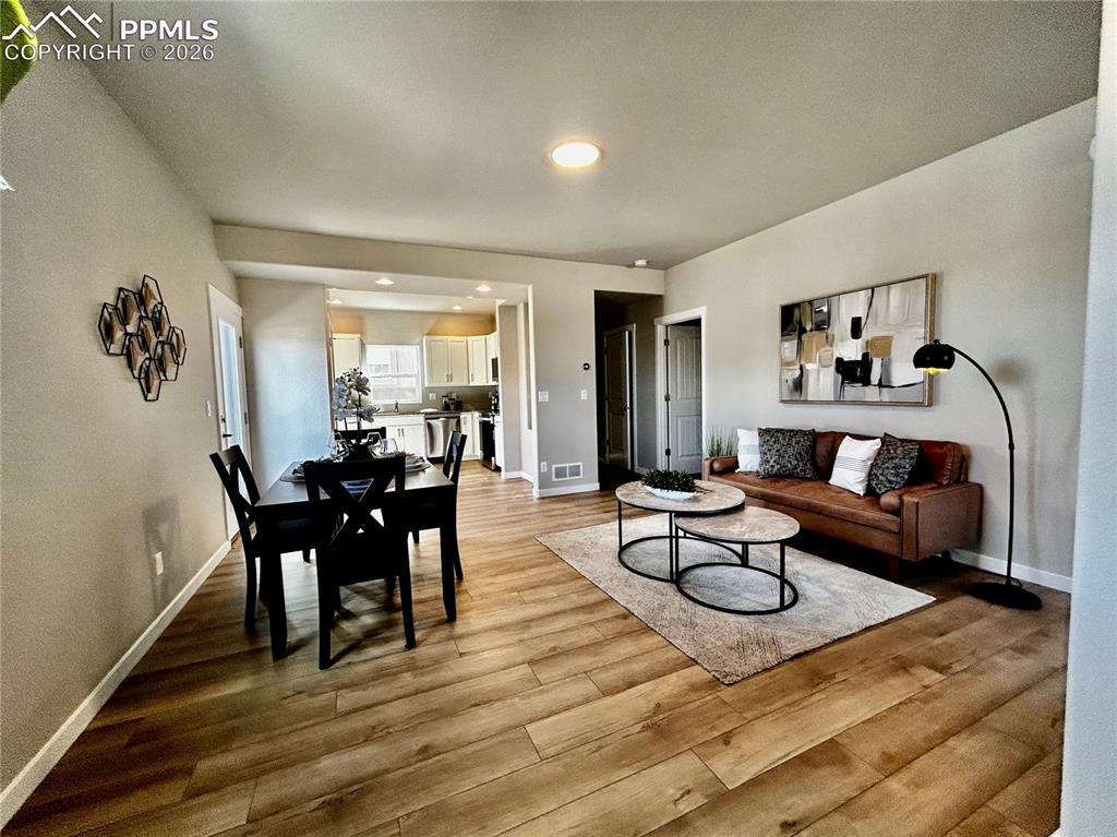 Image 3 of 14: Living area featuring baseboards and light wood-style flooring