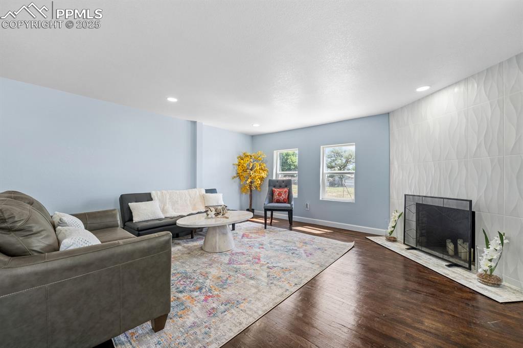 Image 10 of 50: Sitting area featuring wood finished floors and recessed lighting