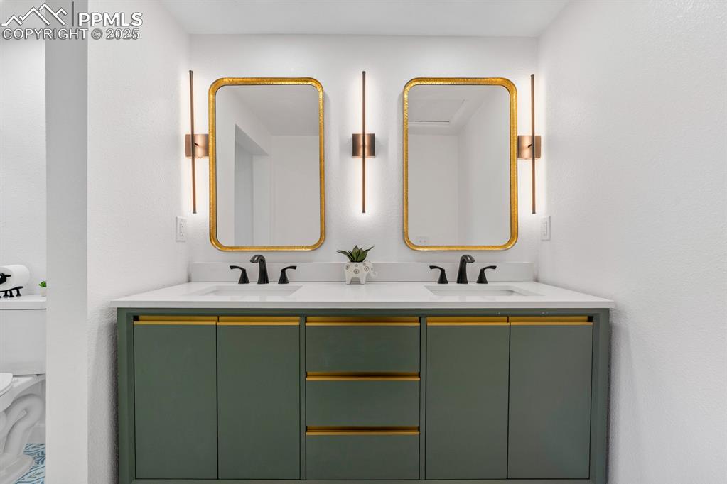 Image 25 of 50: Full bath featuring double vanity and toilet