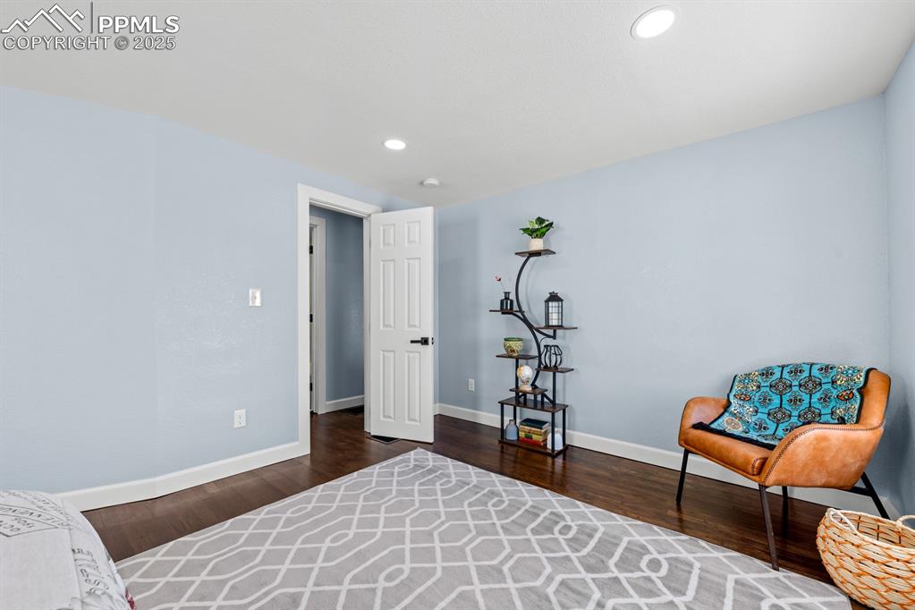 Image 28 of 50: Living area featuring wood finished floors and recessed lighting