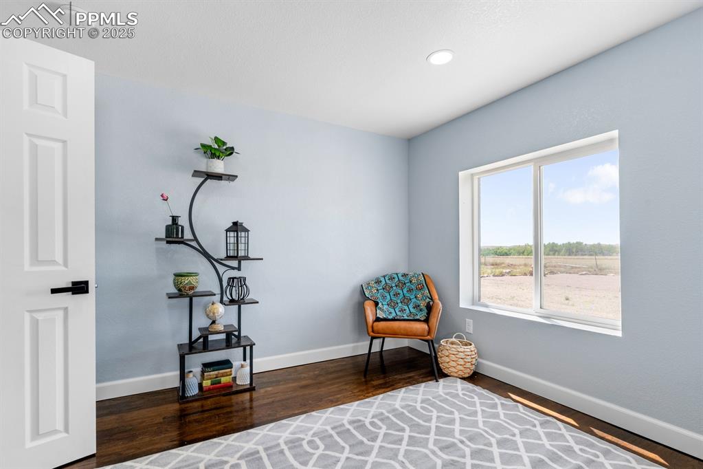 Image 29 of 50: Living area featuring wood finished floors and recessed lighting