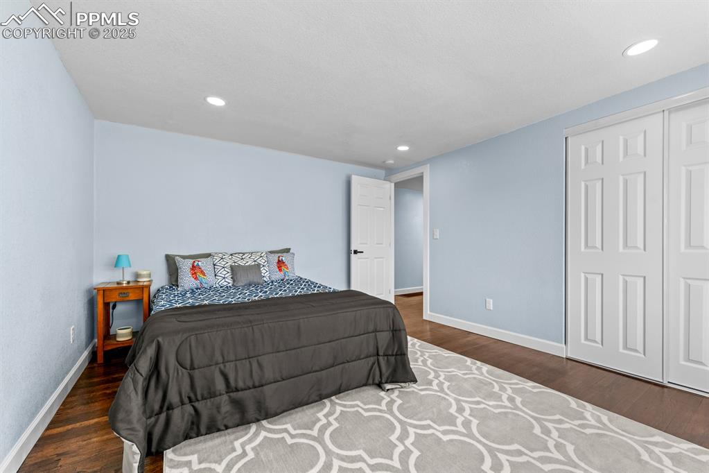 Image 34 of 50: Bedroom featuring wood finished floors and recessed lighting
