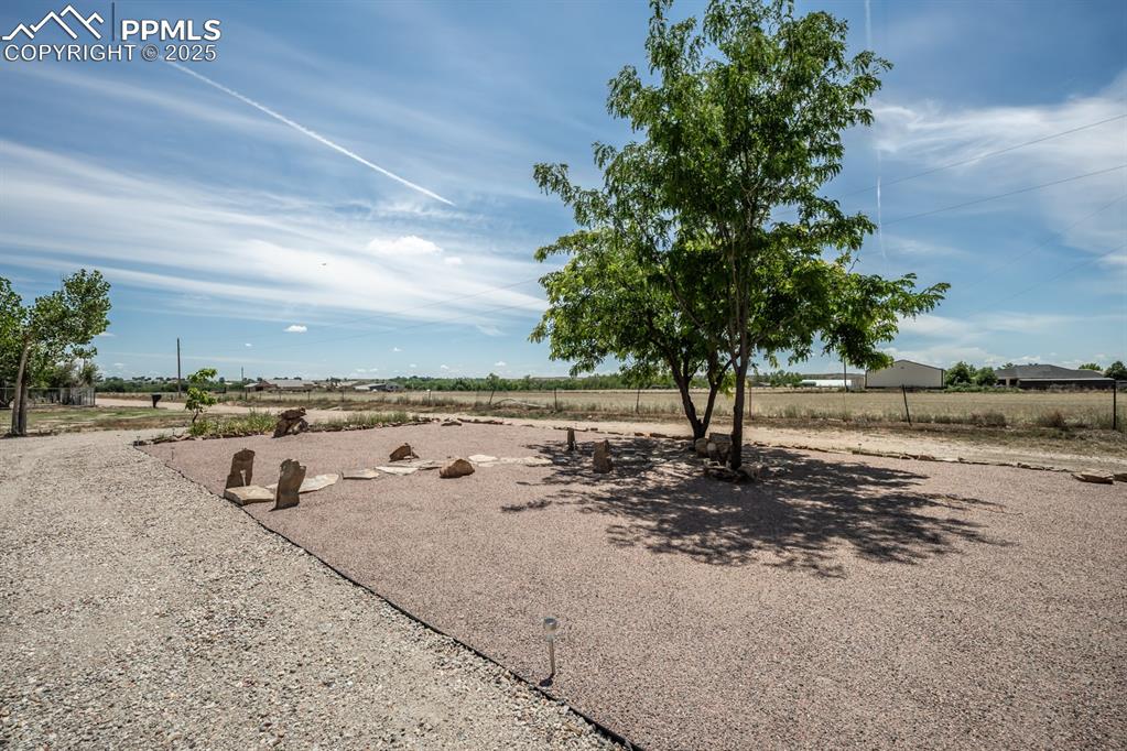 Image 8 of 50: Living area with wood finished floors, a large fireplace, and recessed ligh