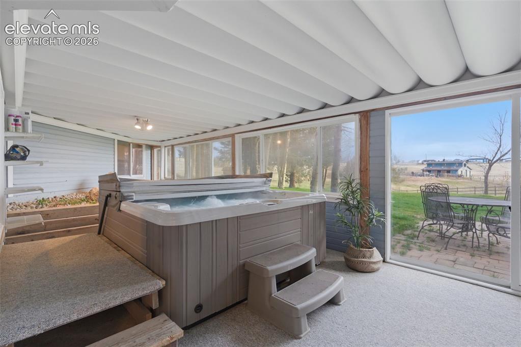 Image 22 of 50: Sun Room with Hot Tub