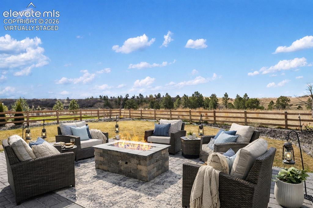 Image 3 of 41: Firepit with a view of nature preserve and mountains. Virtually staged