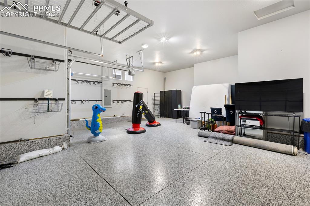 Image 34 of 41: 3 car garage with coated floor