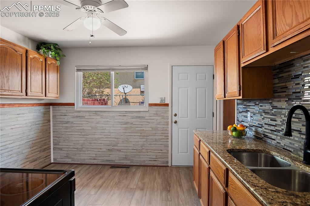 Image 10 of 25:  Charming Eat-In Kitchen Features Oak Cabinetry, Granite Counters,  Custom 